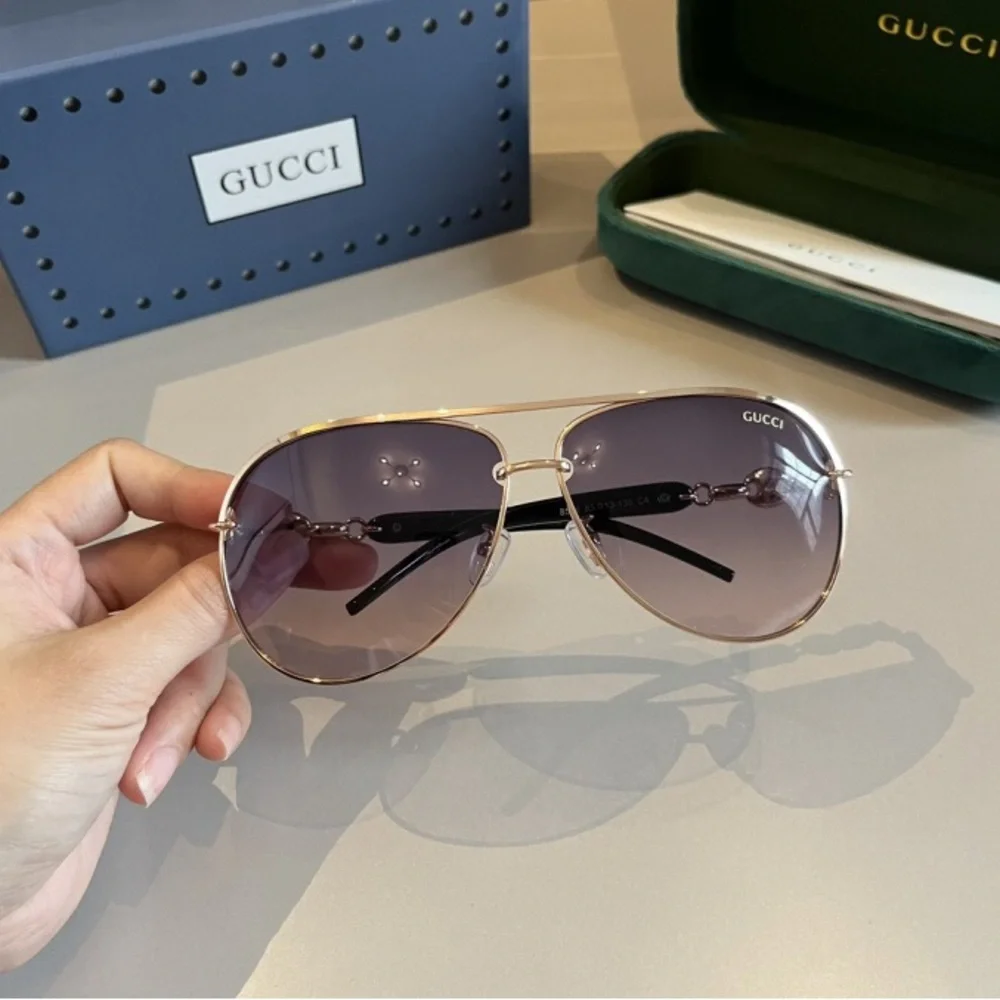 Gucci Women's Black and Gold Sunglasses